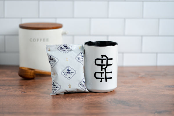 French Roast Frac Pack next to a Reading Coffee Company Mug