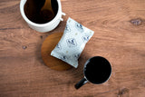 Frac Pack with a jar of coffee grounds and a coffee mug