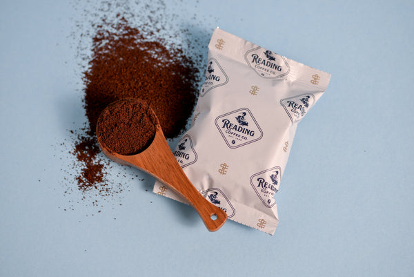 Frac Pack Breakfast Blend with coffee grinds around the pack