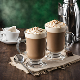 Two fancy glass coffee mugs with coffee and whipped cream