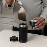 User cold brew filter bag being removed from toddy go brewer